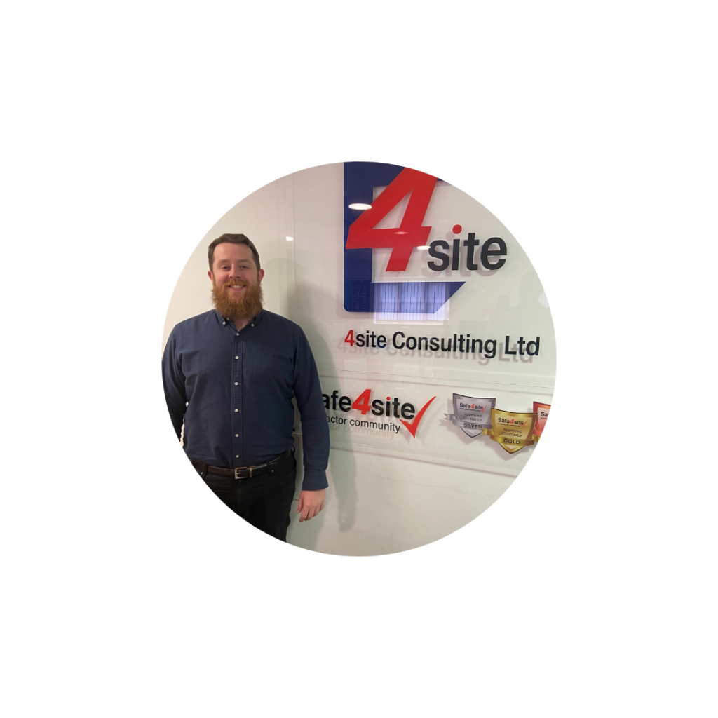 A photo of our new Health, Safety and Fire Advisor Scott - standing in our office in front of the 4site sign.